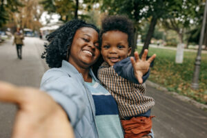 Mother and son hugging and looking happy, spending time together