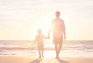 Father and son walking a beach